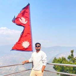 HICH:Proud moment with the Nepali flag and stunning mountain views! Rate it out :)